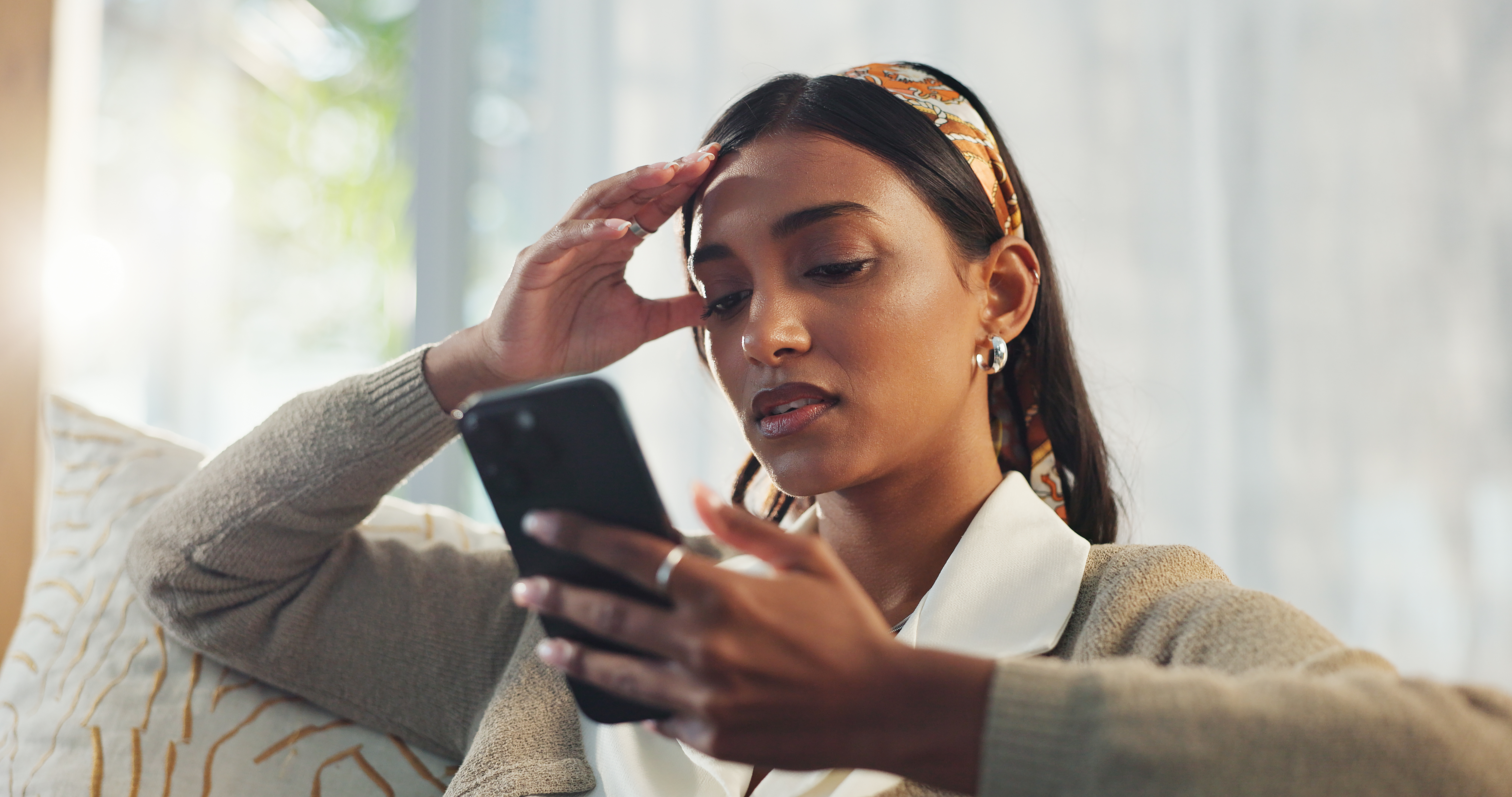Woman looking at her phone as she is getting a call.