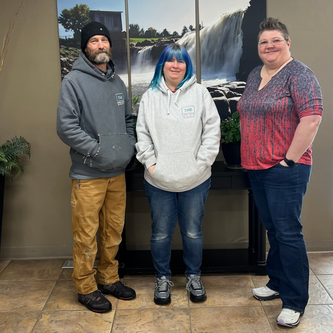 three people smiling at our falls landing branch