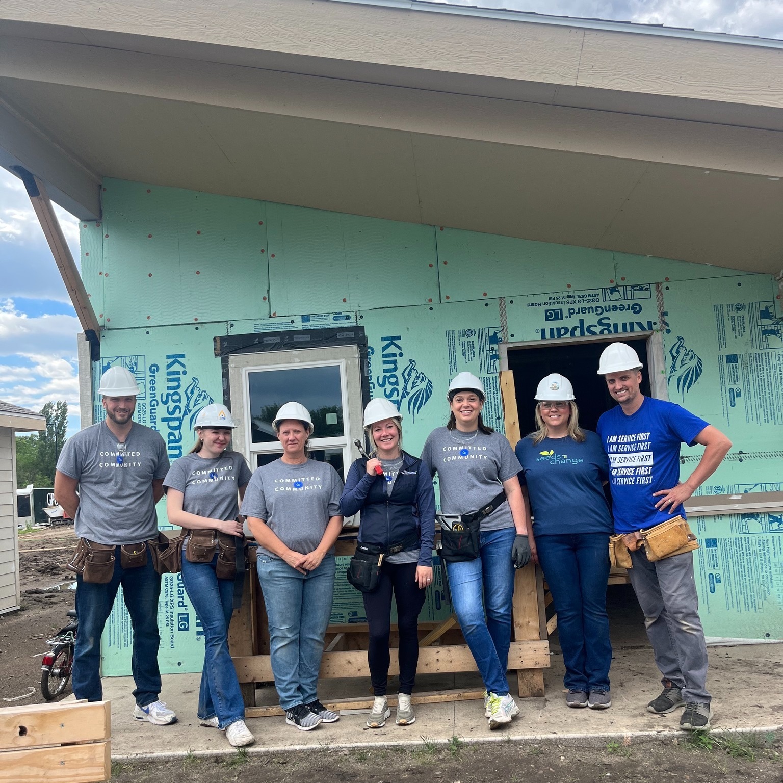 A group of Service First employees volunteering at a build site.