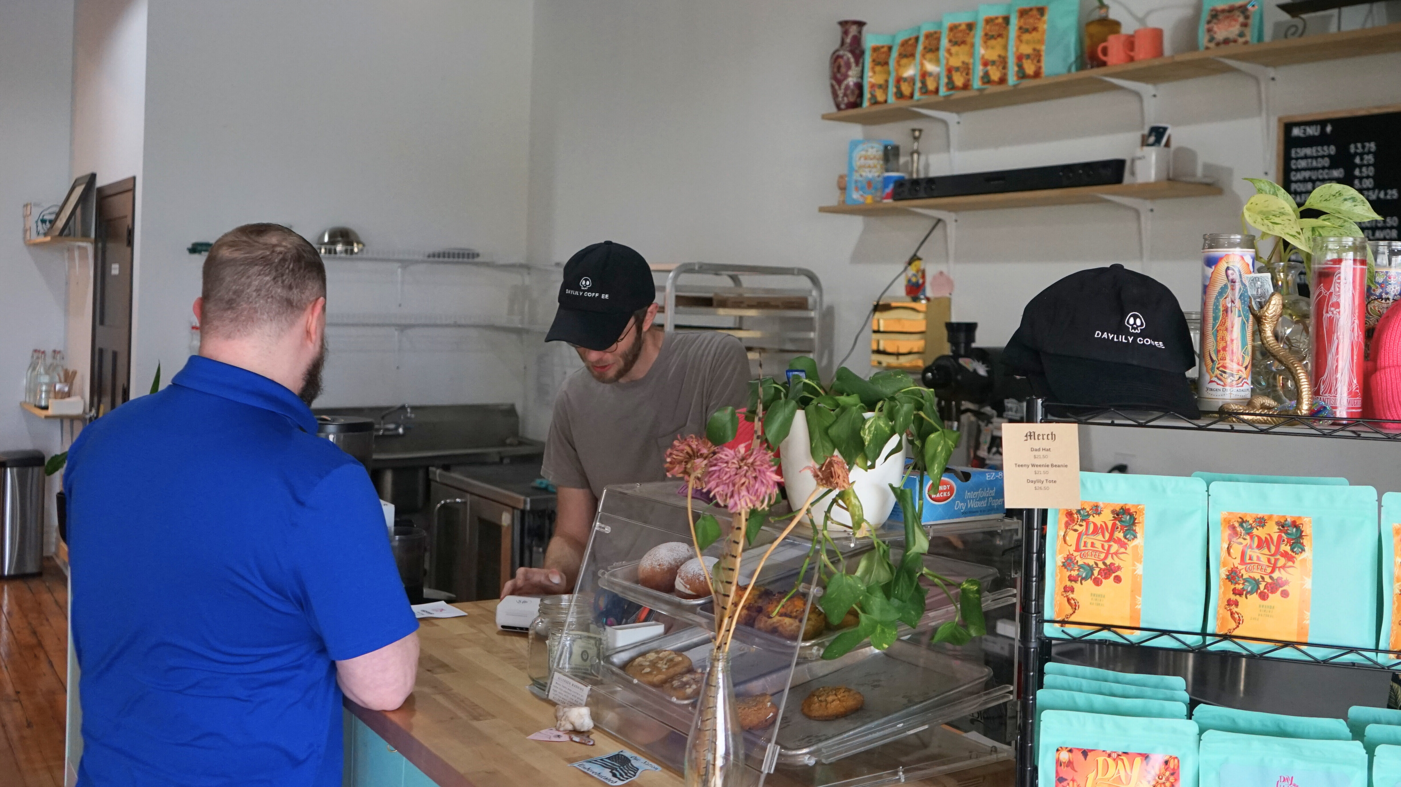 A customer pays for coffee at a cafe