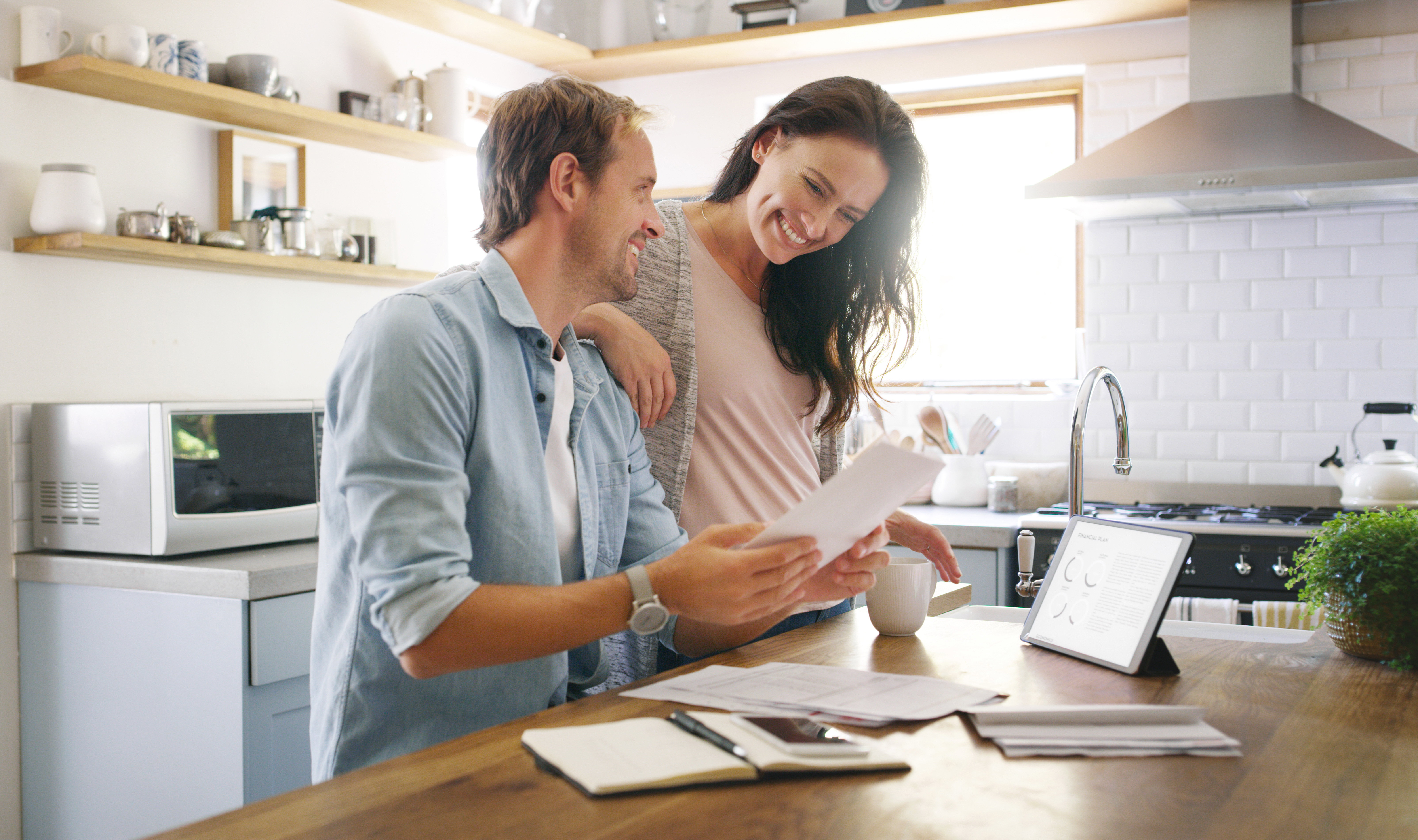 couple in their kitchen going through bills