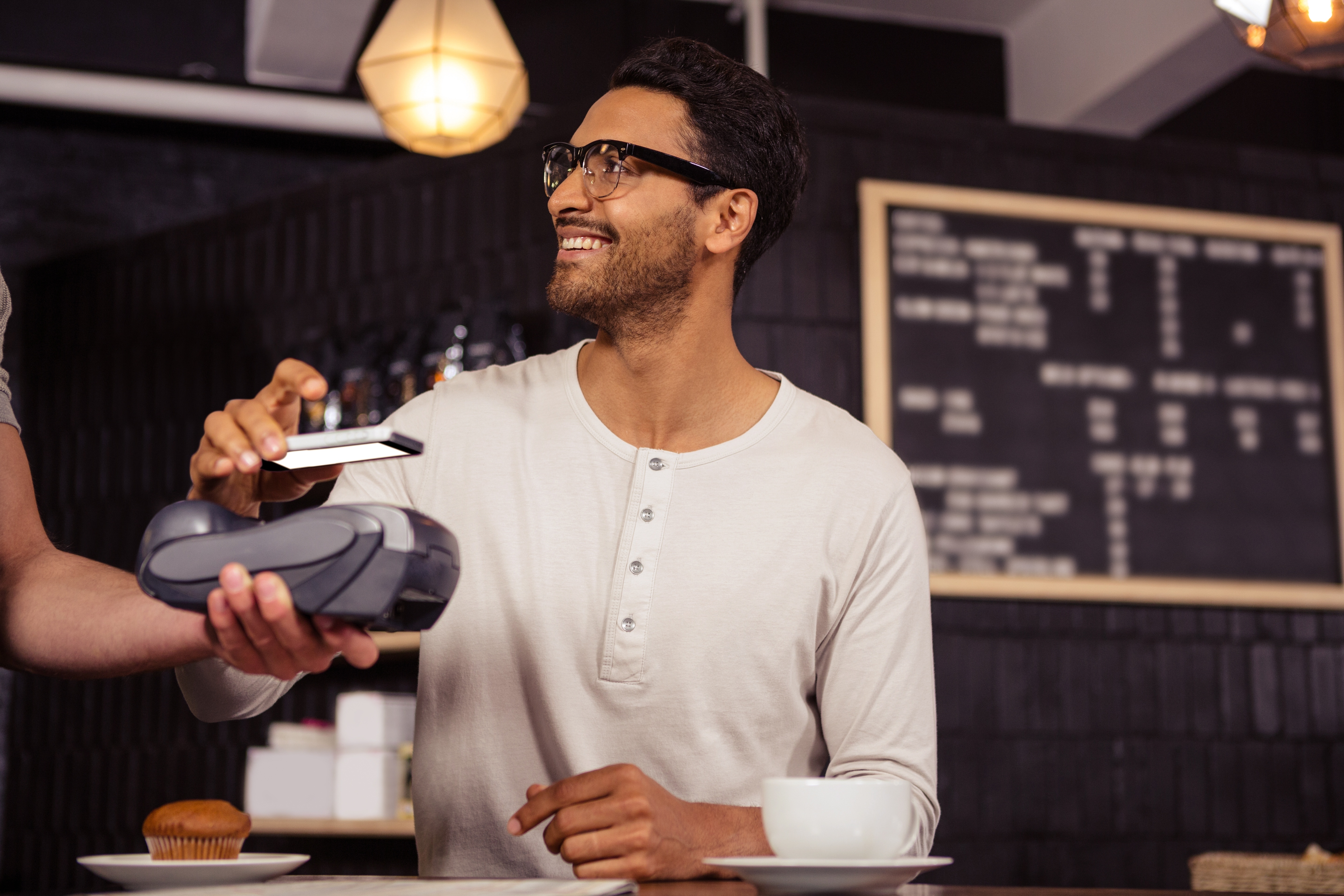 man paying for coffee with digital wallet