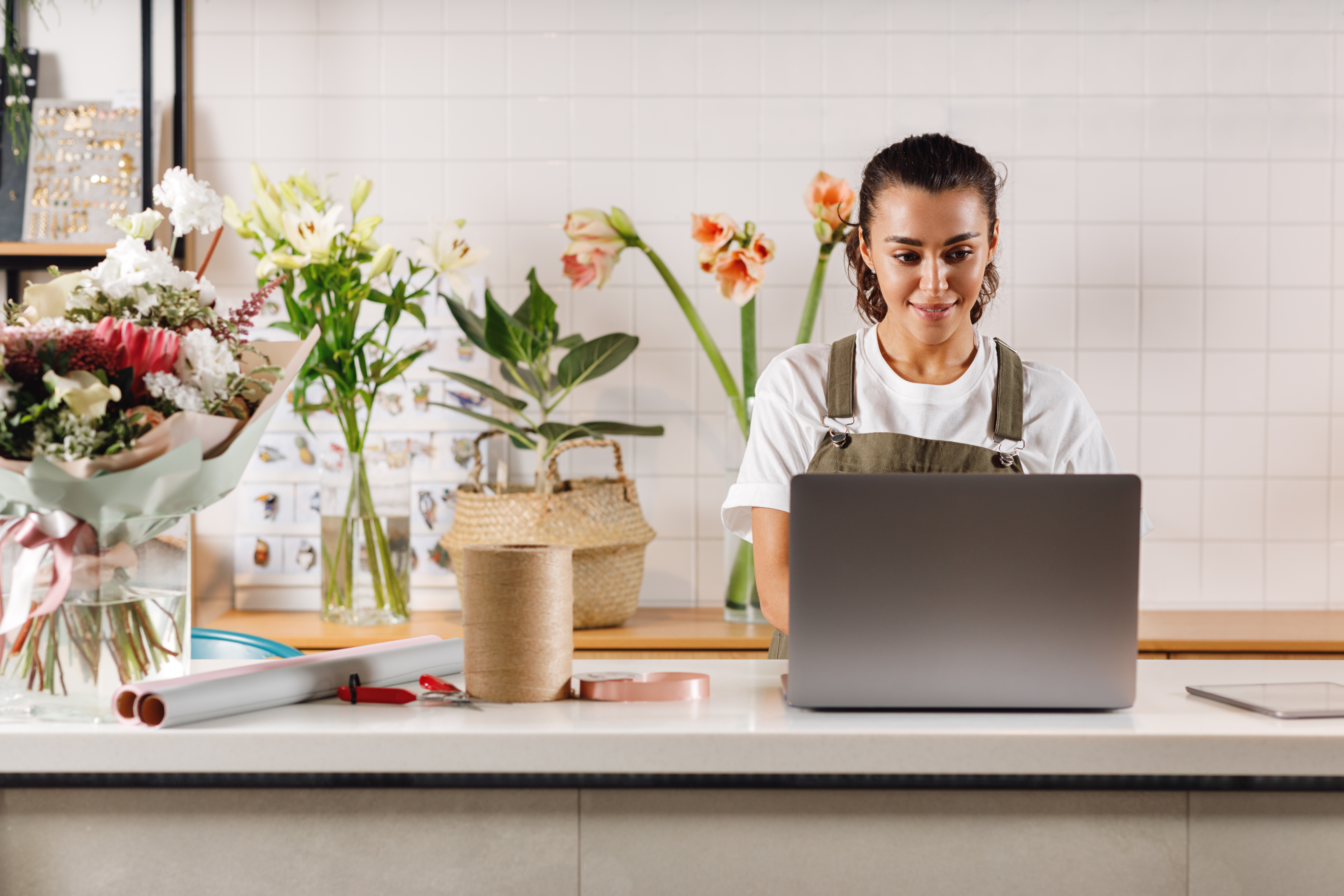 owner of flower shop on her laptop