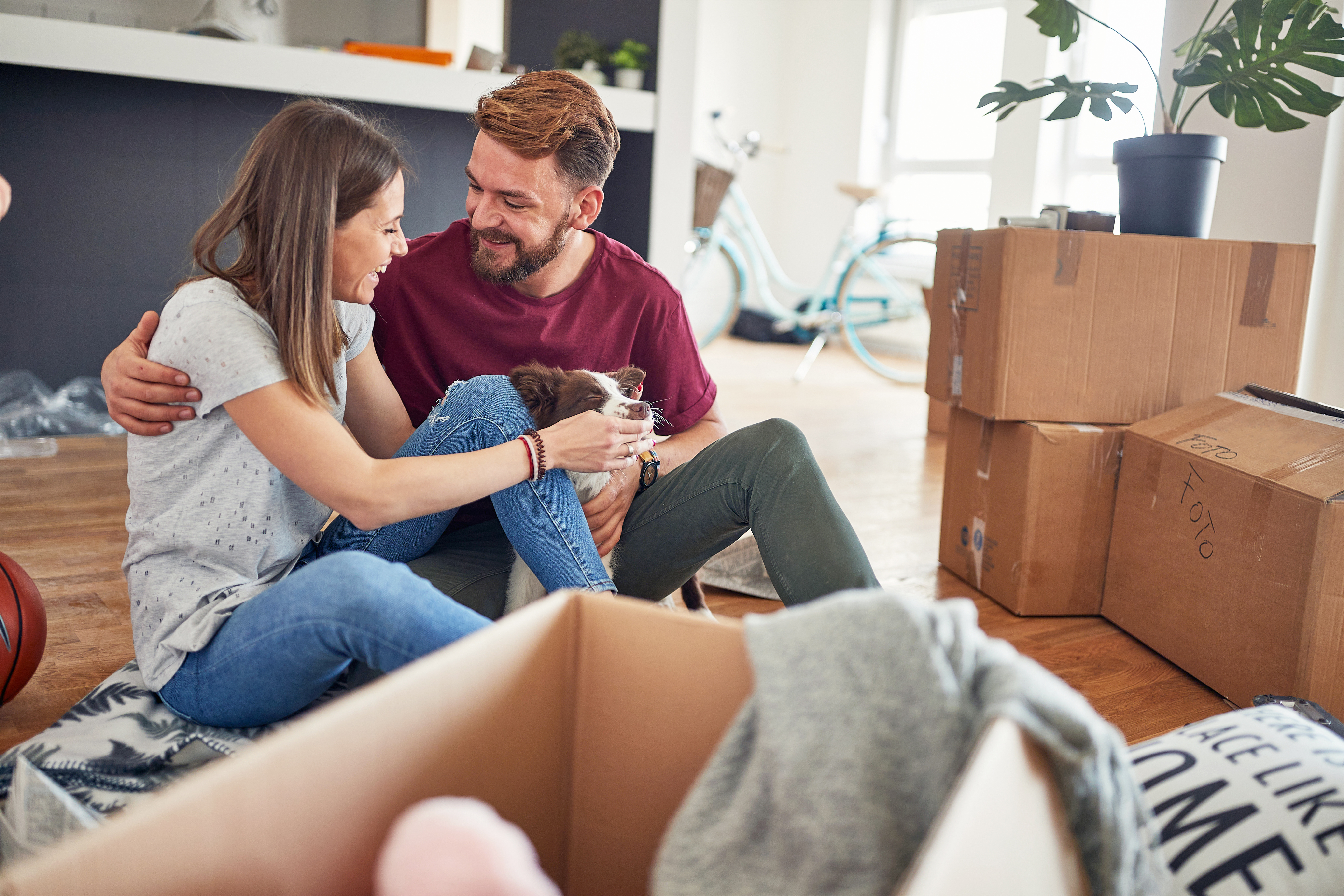 couple with their dog as they move into their new home