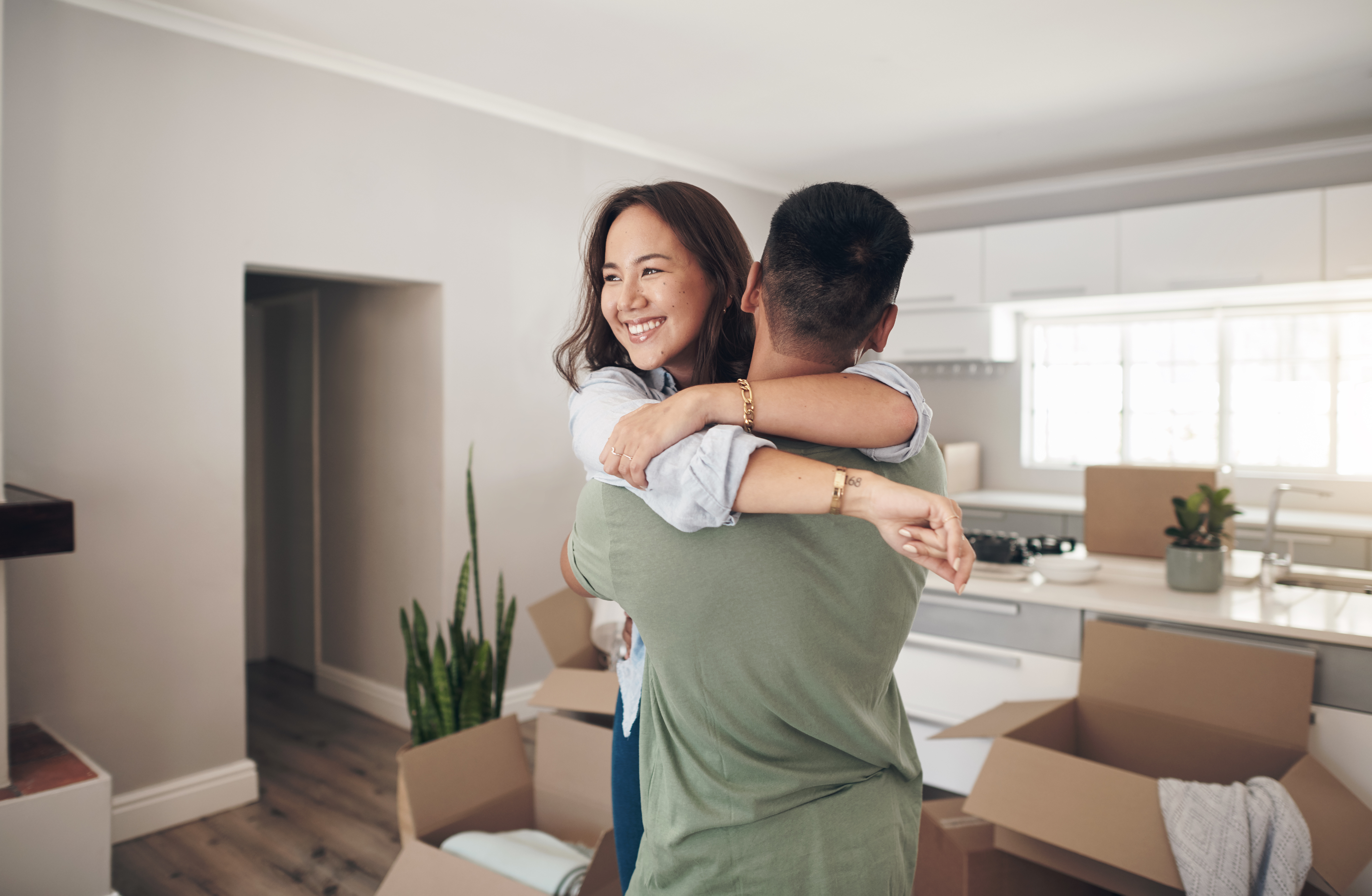 couple happily hugging in their newly purchased home